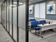 conference room with a row of tables and blue chairs with accordion-style glass doors pulled out