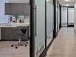 hallway with glass frosted sliding barn doors leading to medical exam rooms